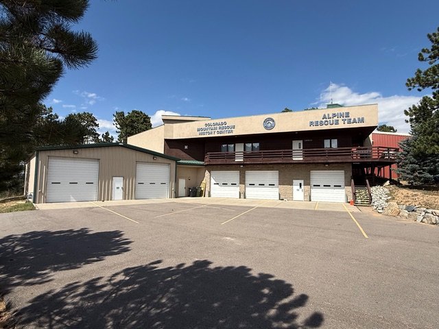 The Colorado Mountain Rescue History Center and Alpine Rescue Team building in Evergreen, among pine trees